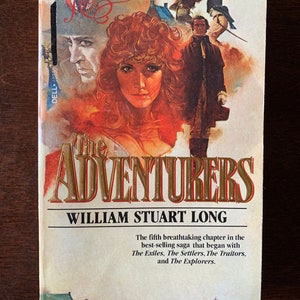 May include: The Adventurers book cover, volume 5 of the series, featuring a woman with red hair and a man in a black coat. The title is in gold lettering on a red background. The text reads "The fifth breathtaking chapter in the best-selling saga that began with The Exiles, The Settlers, The Traitors, and The Explorers."