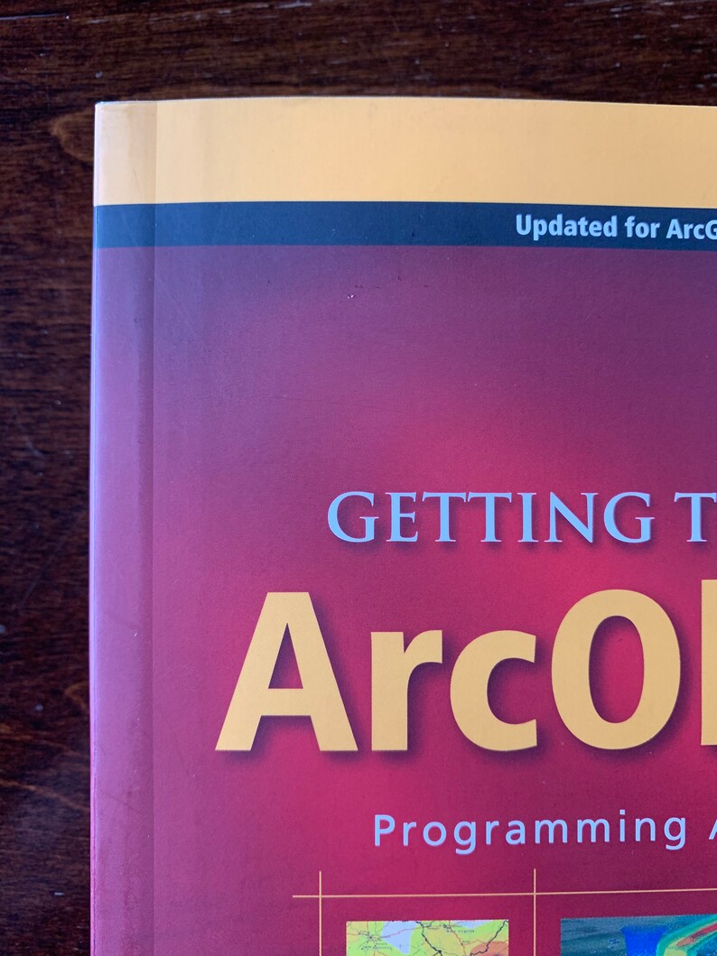 Peut inclure: Un livre rouge avec le titre "GETTING STARTED WITH ArcGIS Programming" en texte blanc et "ArcGIS" en texte jaune. Le livre a une bande noire et jaune en haut avec le texte "Updated for ArcGIS 10.1" en texte blanc.