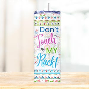 May include: A tall, insulated tumbler with a lid and straw. The tumbler features a colorful design with the text "Don't Touch My Rack!" in various fonts and colors, along with Mahjong tile illustrations. The design includes floral and geometric patterns.
