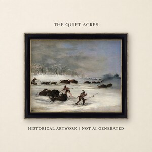 May include: A framed historical painting titled THE QUIET ACRES depicting a winter scene with figures on snowshoes hunting a herd of bison in a snowy landscape. The artwork is enclosed in a black frame with gold inner trim. Text reads HISTORICAL ARTWORK | NOT AI GENERATED.