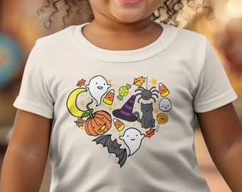 May include: White t-shirt with a heart-shaped design featuring various Halloween-themed illustrations, including a ghost, pumpkin, spider, cat, witch's hat, candy corn, and a crescent moon.