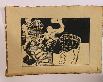 May include: Black and white linocut print of a character with a helmet and a large fist raised in the air. The character is surrounded by smoke and the background is black. The print is signed "Raz" in the bottom right corner.