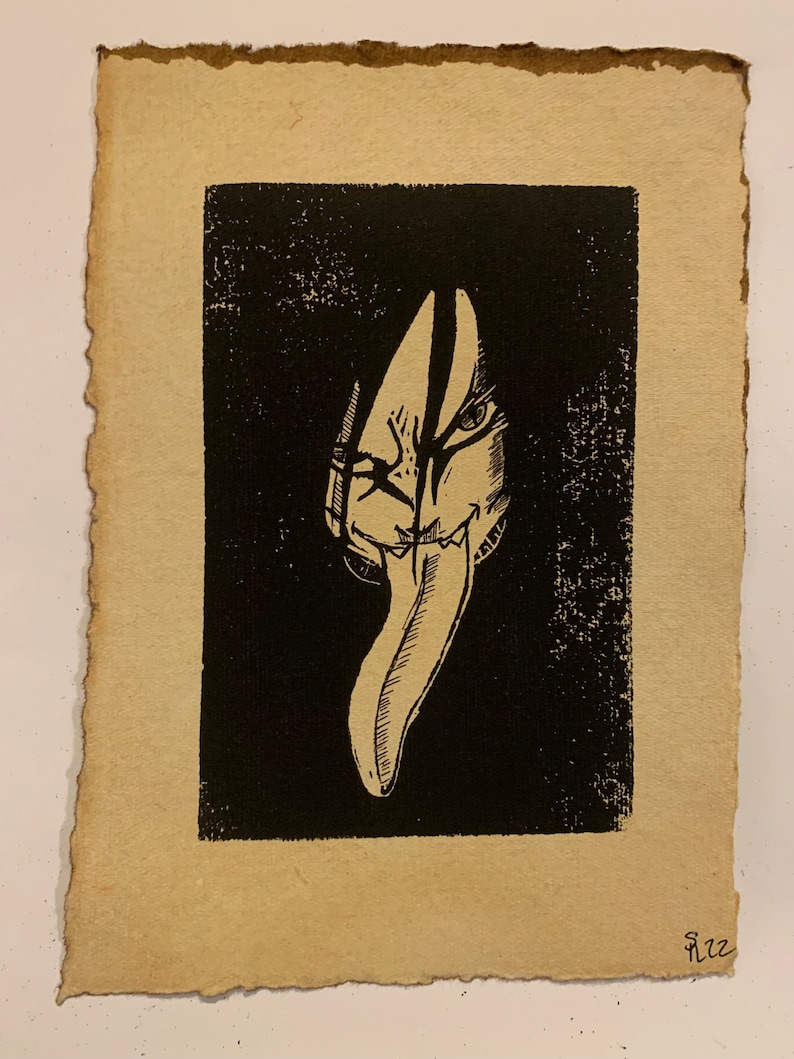 May include: Black and white print of a stylised face with a long, pointed tongue. The face is partially obscured by a dark background.