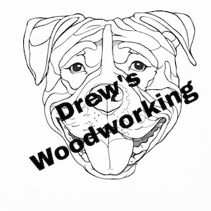 May include: Black and white line art illustration of a dog's face, with the text "Drew's woodworking" in a diagonal font across the image. The dog has a wide open mouth and a long tongue.