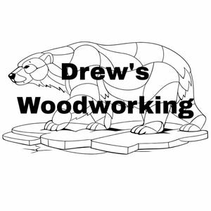 May include: Black and white line art illustration of a polar bear standing on ice floes. The text "Drew's Woodworking" is displayed in bold, black letters above the bear. The bear is segmented with lines.