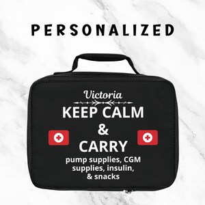 May include: Black personalized medical supply bag with the name "Victoria" above the words "KEEP CALM & CARRY". The bag includes two red medical symbols and text that reads "pump supplies, CGM supplies, insulin, & snacks".