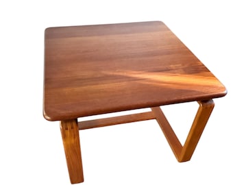 May include: A mid-century modern teak wood side table with a square top and a unique angled base.