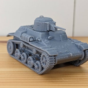 May include: A gray model tank with a detailed design, featuring a turret, cannon, and tracks. The miniature military vehicle is made of a solid material and sits on a wooden surface.