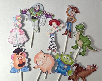 May include: A set of 10 Toy Story character cake toppers. The characters include Woody, Buzz Lightyear, Jessie, Rex, Hamm, Slinky Dog, Bo Peep, Mr. Potato Head, and Alien. The toppers are printed on cardstock and attached to wooden dowels.