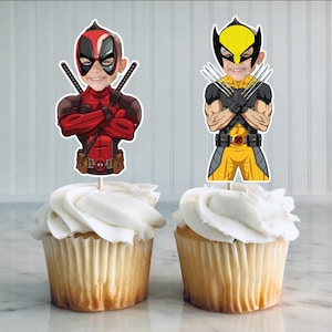 May include: Two cupcake toppers featuring cartoon characters. The first topper is of Deadpool, a superhero with a red and black suit, holding two katanas. The second topper is of Wolverine, a superhero with a yellow and black suit, holding his claws.