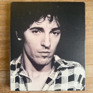 May include: A distressed wooden sign with the words "Welcome to our home" in white. The sign has a rustic finish, ideal for a porch or hallway, and is designed to create a welcoming atmosphere.