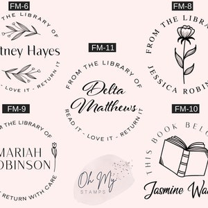 May include: A set of ten black and white rubber stamps with different designs. The stamps are circular and feature various floral and book-themed illustrations. The text on the stamps includes names, phrases like "From the Library of" and "Read it - Love it - Return it", and the company name "Oh My Stamps".