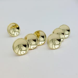 May include: A white ceramic mug with a black handle and the text "But First, Coffee" in a handwritten style. The mug is on a white surface. The mug is approximately 4 inches tall.