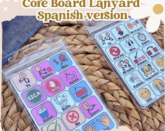 May include: Two clear plastic lanyards with colorful communication boards. Each board features illustrated icons and Spanish words. The text "Mini AAC Core Board Lanyard Spanish version" is at the top. The bottom of the image reads "The Little ADAPTIVE Classroom."