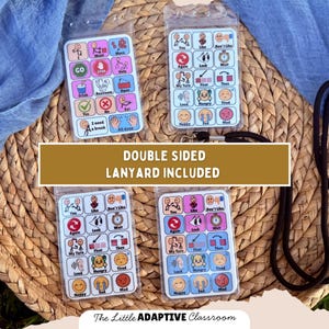 May include: Four double-sided communication boards with a lanyard. Each board features colorful icons and text for various needs and feelings. The boards are displayed on a woven basket with a blue fabric background. Text on the image reads "DOUBLE SIDED LANYARD INCLUDED."