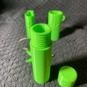 May include: A set of three lime green 3D printed containers with a leaf design. The containers are cylindrical and have a screw-on lid.