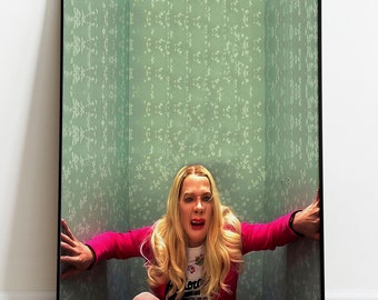 May include: A woman with blonde hair is trapped in a small room with green patterned wallpaper. She is wearing a pink jacket and white shirt. She is looking at the camera with a scared expression.