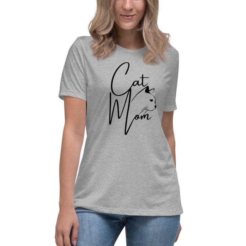 May include: A heather grey t-shirt with a black graphic that says "Cat Mom" with a stylized cat head silhouette.