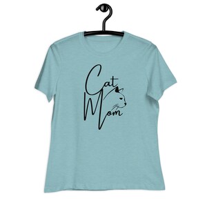 May include: A light blue t-shirt with the text "Cat Mom" in black script with a black cat silhouette.