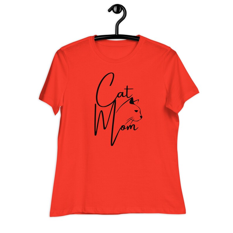 May include: A bright orange t-shirt with the text "Cat Mom" in black script with a cat's head silhouette.