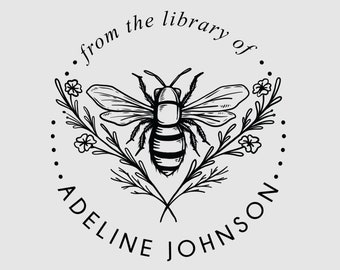 May include: Black and white illustration of a bee with wings spread, surrounded by flowers and leaves. The text "from the library of... ADELINE JOHNSON" is written in a circle around the bee.