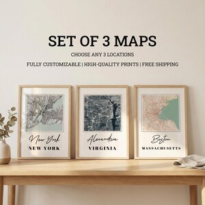 May include: A set of three framed wall art prints featuring detailed street maps of New York, Alexandria, and Boston. Each print displays a specific city layout with text labels for the city and state names in a clean, modern, and minimalist style.
