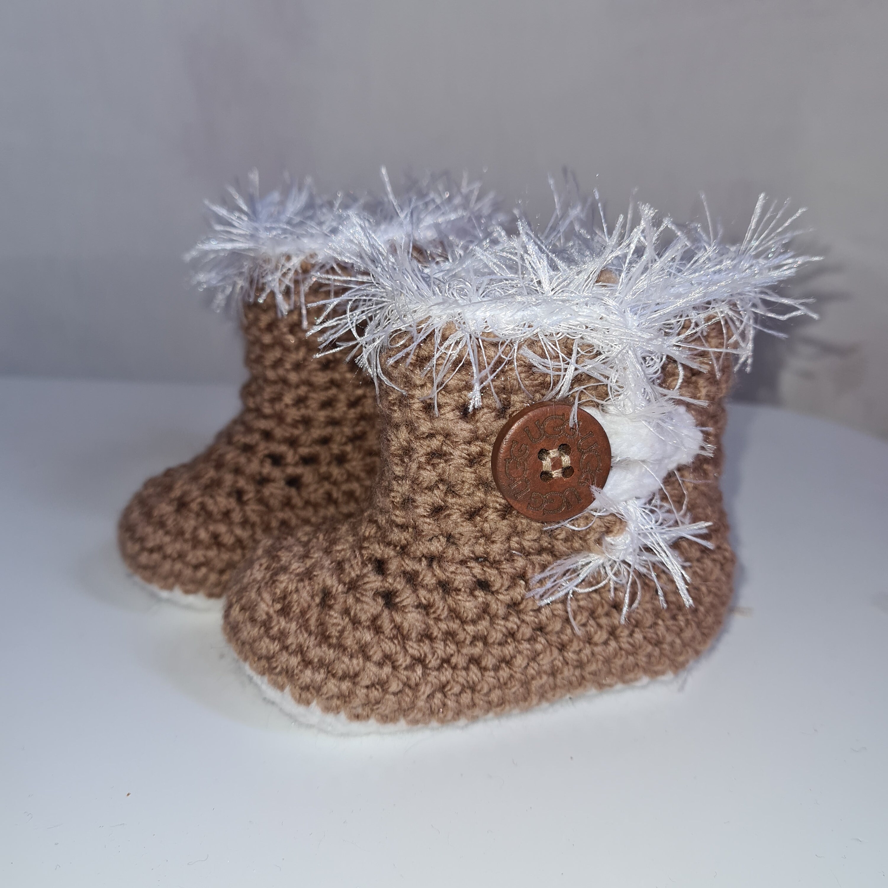 Hand crocheted Baby Ugg Bootees With Eyelash Trim and Ugg Button