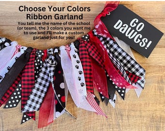 May include: A ribbon garland with red, black, and white ribbons. The garland includes ribbons with paw prints, polka dots, and gingham patterns. A black tag with "GO Dawgs!" is attached. Text on the image reads "Choose Your Colors Ribbon Garland".