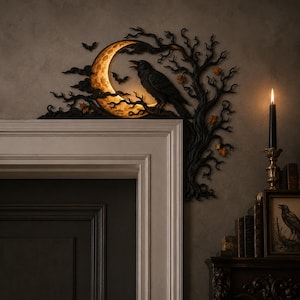 May include: A black decorative door corner accent featuring a crescent moon with a warm glow, a perched raven, and bare tree branches. Small bats are silhouetted against the moon, and orange leaves are scattered among the dark, twisted branches.