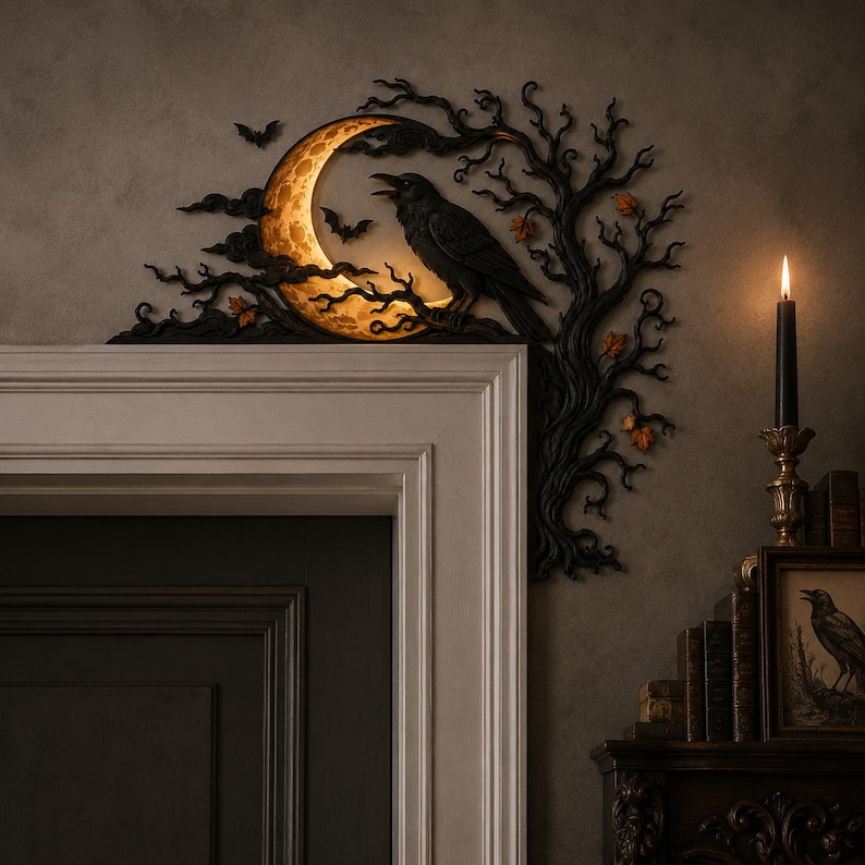 May include: A black decorative door corner accent featuring a crescent moon with a warm glow, a perched raven, and bare tree branches. Small bats are silhouetted against the moon, and orange leaves are scattered among the dark, twisted branches.