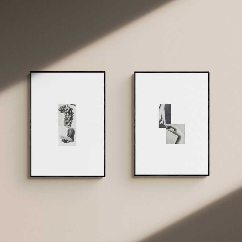 May include: Two black framed prints with black and white images. The print on the left features a woman with a bunch of grapes over her head. The print on the right features two hands reaching towards each other.