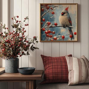 May include: A framed painting of a cardinal bird perched on a branch with red berries. The background is a blue and white winter scene.