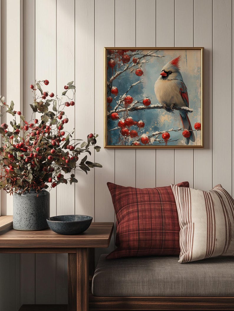 May include: A framed painting of a cardinal bird perched on a branch with red berries. The background is a blue and white winter scene.