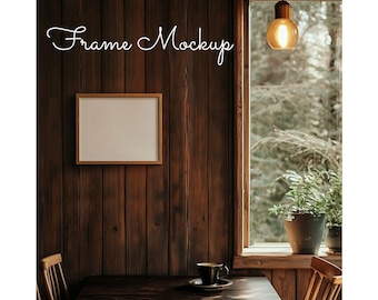 May include: A wooden framed picture mockup with a white background, hanging on a dark wood wall. A wooden table with a cup and saucer sits in front of the frame. A window with a view of trees and a hanging light fixture is in the background.