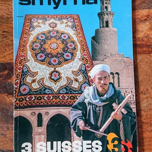 May include: A vintage magazine cover featuring a colorful rug with a floral design, a man playing a musical instrument, and a minaret in the background. The cover reads "smyrna" and "3 SUISSES".
