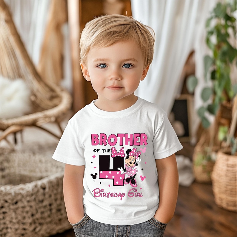 May include: A white t-shirt with the text "BROTHER OF THE 4 BIRTHDAY GIRL" in pink. The number 4 is in black with pink polka dots. Minnie Mouse is also featured on the shirt.