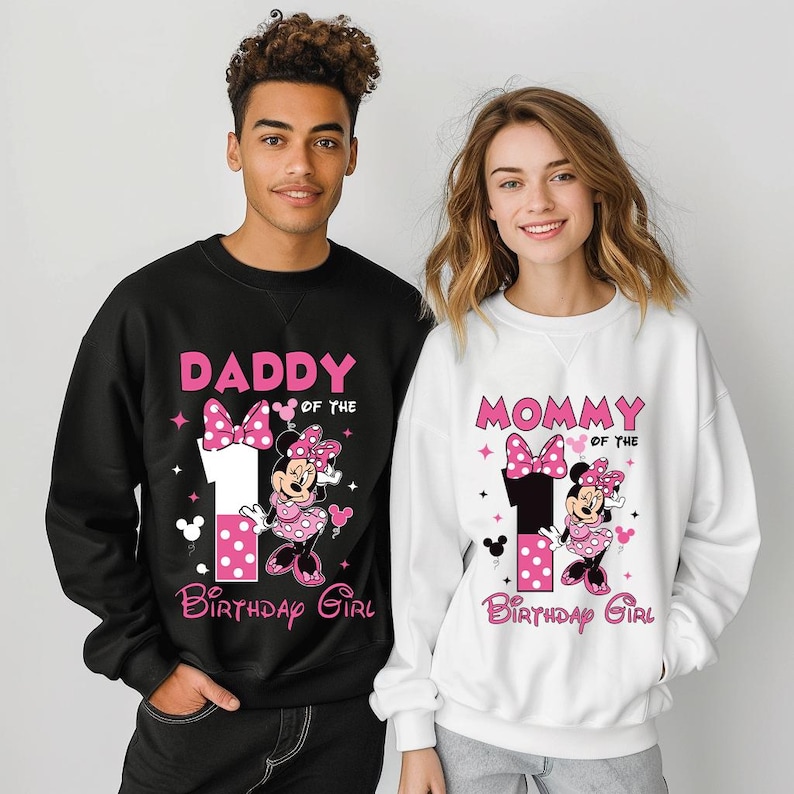 May include: Black and white sweatshirts with Minnie Mouse graphics. The black sweatshirt says "Daddy of the Birthday Girl" and the white sweatshirt says "Mommy of the Birthday Girl". Both have a large number 1.
