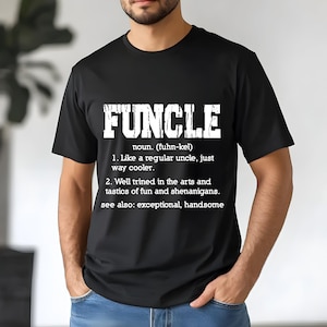 May include: Black t-shirt with the word "FUNCLE" in bold white letters. Below the word is a definition: "noun. (fuhn-kel) 1. Like a regular uncle, just way cooler. 2. Well trined in the arts and tastics of fun and shenanigans."