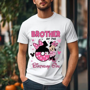 May include: White t-shirt with the text "BROTHER of the BIRTHDAY GIRL" in pink. The design includes a large number 6 with a pink polka dot pattern, a Minnie Mouse graphic, and pink bow accents.