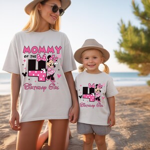 May include: Two white t-shirts with matching designs. One shirt says "Mommy of the 4th Birthday Girl" with a Minnie Mouse graphic. The other shirt says "4th Birthday Girl" with the same Minnie Mouse graphic. Both shirts are worn by a mother and daughter.