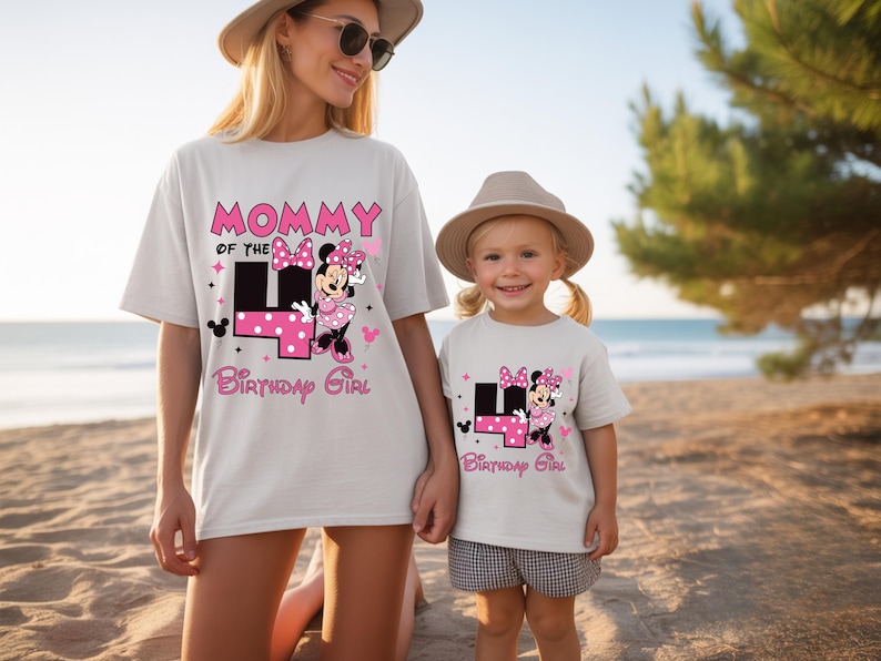 May include: Two white t-shirts with matching designs. One shirt says "Mommy of the 4th Birthday Girl" with a Minnie Mouse graphic. The other shirt says "4th Birthday Girl" with the same Minnie Mouse graphic. Both shirts are worn by a mother and daughter.