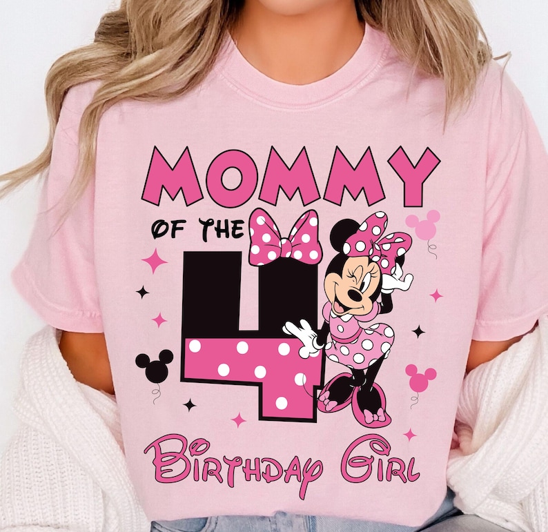 May include: A pink t-shirt with the text "Mommy of the 4 Birthday Girl" in pink and black. It features a Minnie Mouse graphic in a polka dot dress and bow. Includes star and Mickey Mouse head accents.
