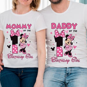 May include: White t-shirts with Minnie Mouse-themed graphics. One shirt says "MOMMY OF THE BIRTHDAY GIRL" and the other says "DADDY OF THE BIRTHDAY GIRL". The design includes a large number 1, a bow, and Minnie Mouse.