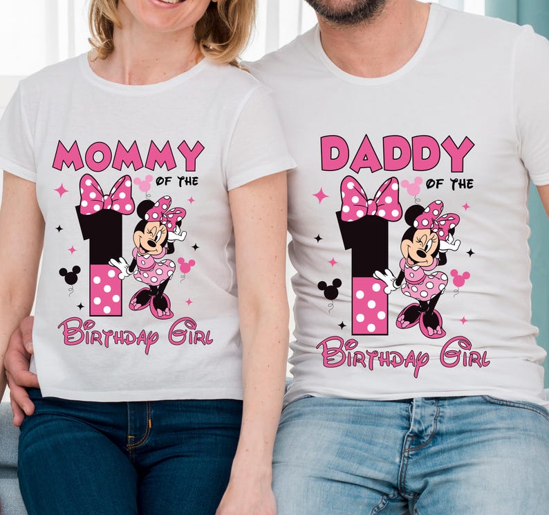 May include: White t-shirts with Minnie Mouse-themed graphics. One shirt says "MOMMY OF THE BIRTHDAY GIRL" and the other says "DADDY OF THE BIRTHDAY GIRL". The design includes a large number 1, a bow, and Minnie Mouse.