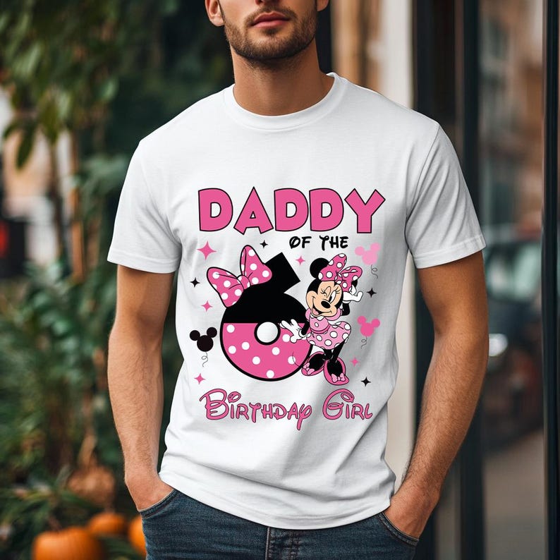May include: White t-shirt with a graphic design featuring the text "DADDY of the Birthday Girl". The design includes a large number 6 with pink polka dots, a Minnie Mouse character, and pink accents.
