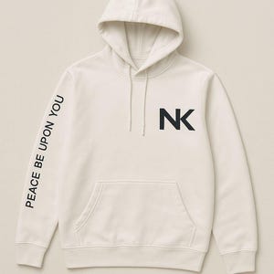 May include: A cream coloured hooded sweatshirt with the text "PEACE BE UPON YOU" printed on the left sleeve and the letter "NK" printed on the front.