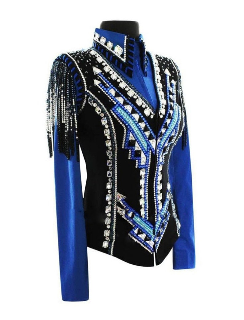 May include: A black show jacket with a blue collar and sleeves. The jacket is decorated with rhinestones and geometric patterns in black, white, and blue.