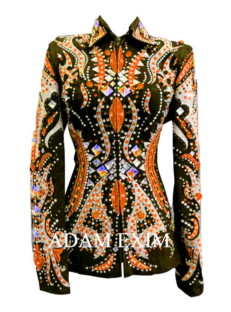 May include: A black show jacket with orange and white embroidery and rhinestones. The jacket has a zipper closure and long sleeves.
