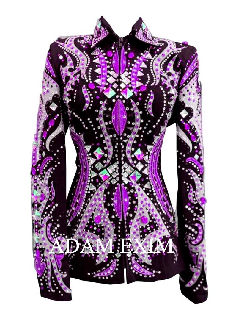 May include: A purple and silver show jacket with a rhinestone design. The jacket has a zipper closure and long sleeves.