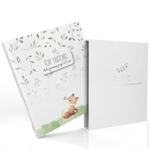 May include: A white book titled "TON HISTOIRE" with French text, featuring a fox and butterfly illustration with green foliage. The book is presented in a matching white box. The design has a soft, watercolour style.
